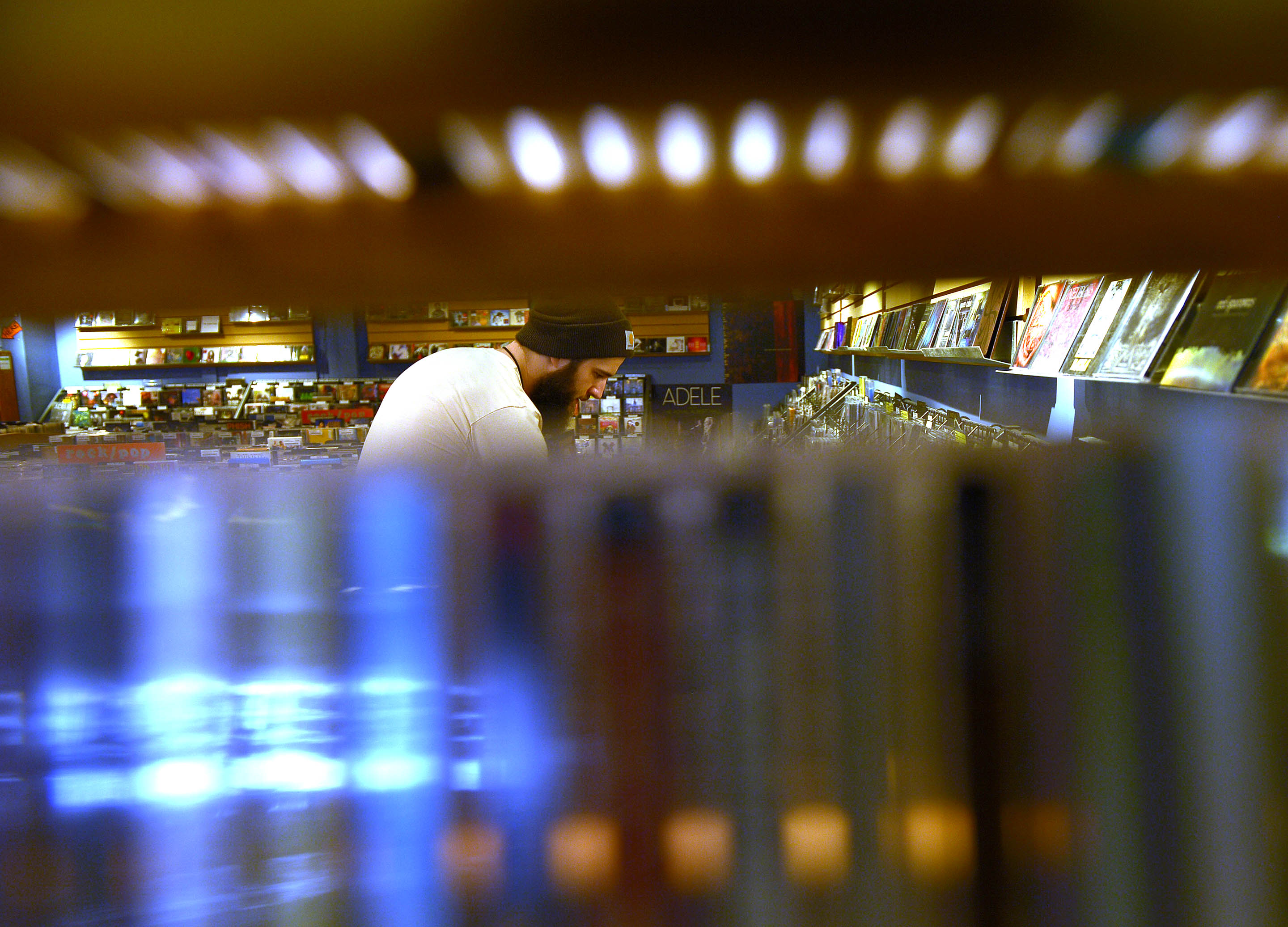 Blake Lundell, 24, looks over the inventory at work at Graywhale Entertainment store in Salt Lake City, March 12, 2014.