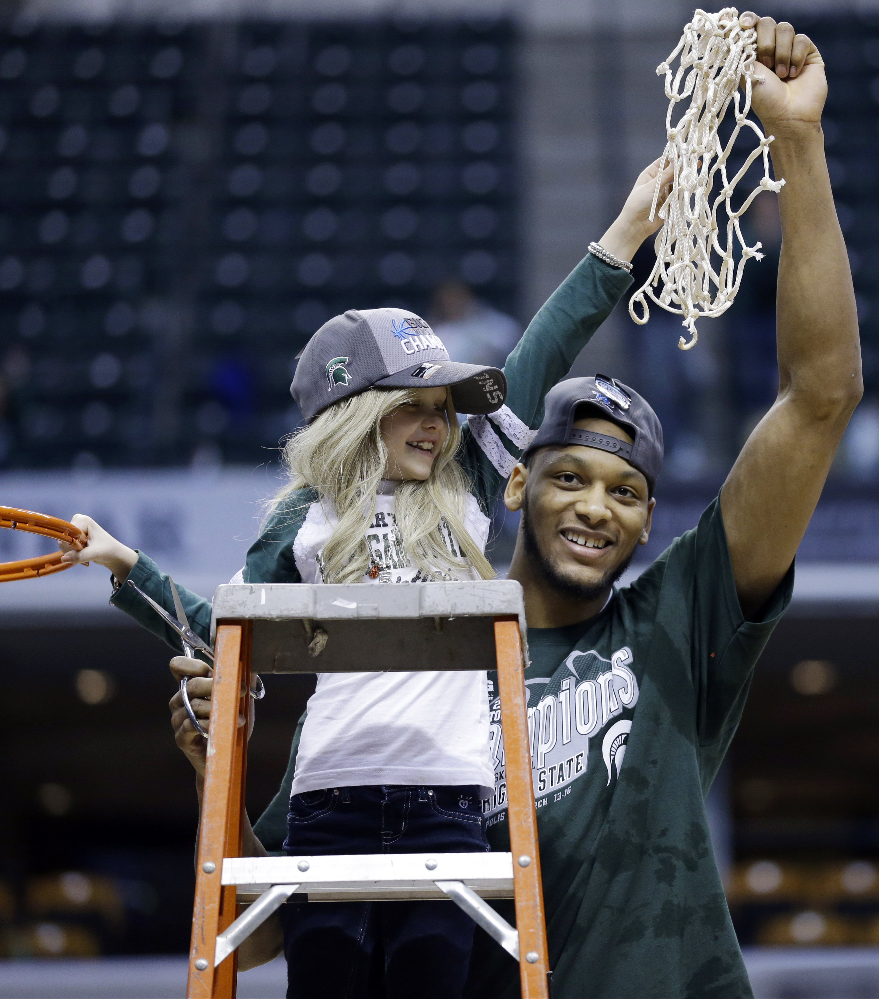 Mich State's Payne treats a little girl as sister