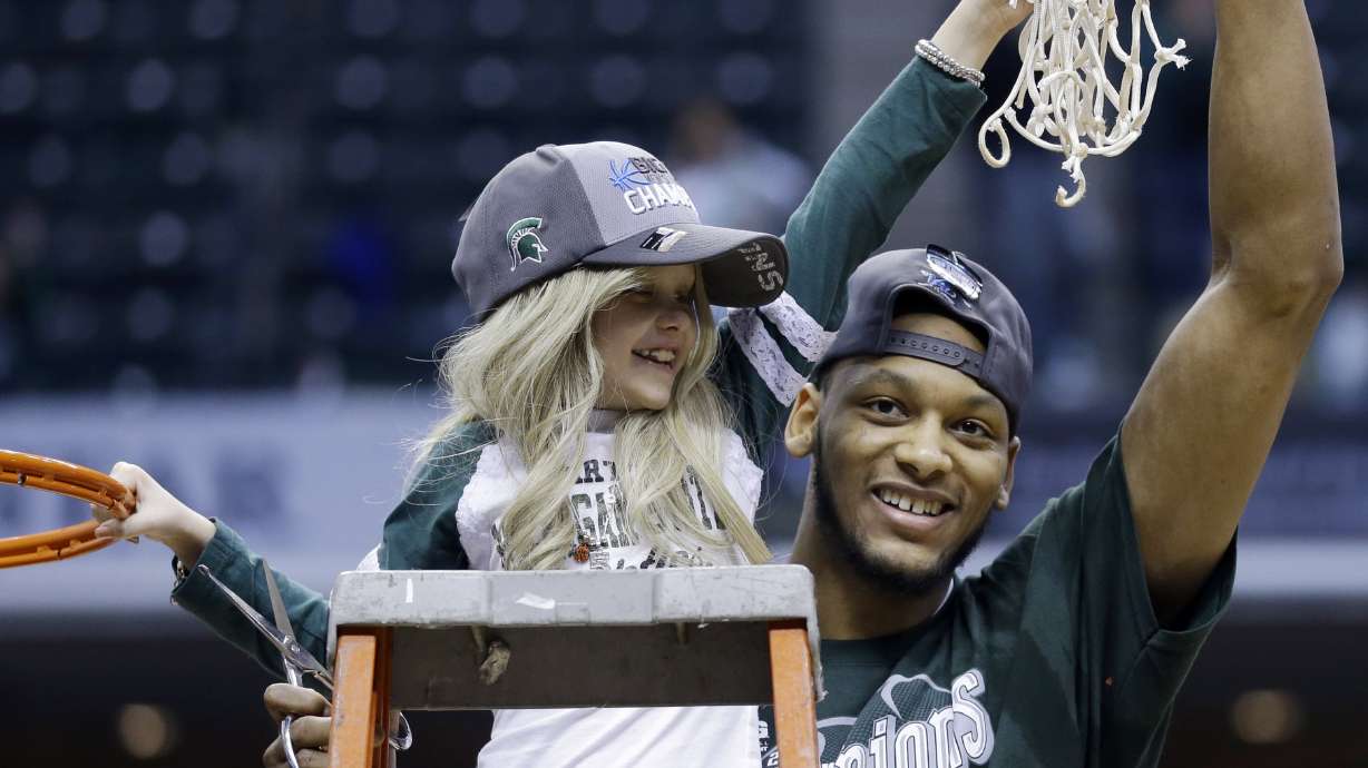 Mich State's Payne treats a little girl as sister
