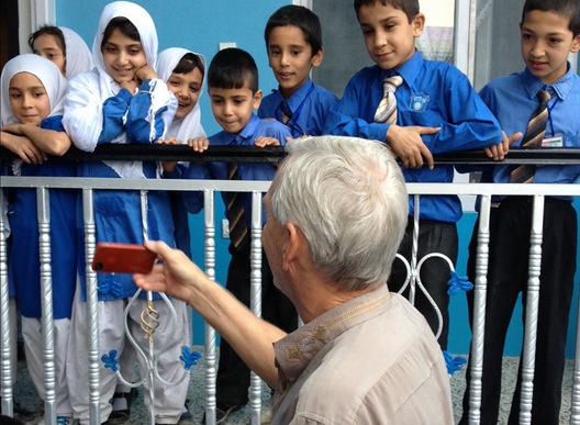 JEFF SHOWING SCHOOLCHILDREN HIS FOOTAGE IN A CAI SCHOOL 
OUTSIDE OF KABUL, AFGHANISTAN, 2013
