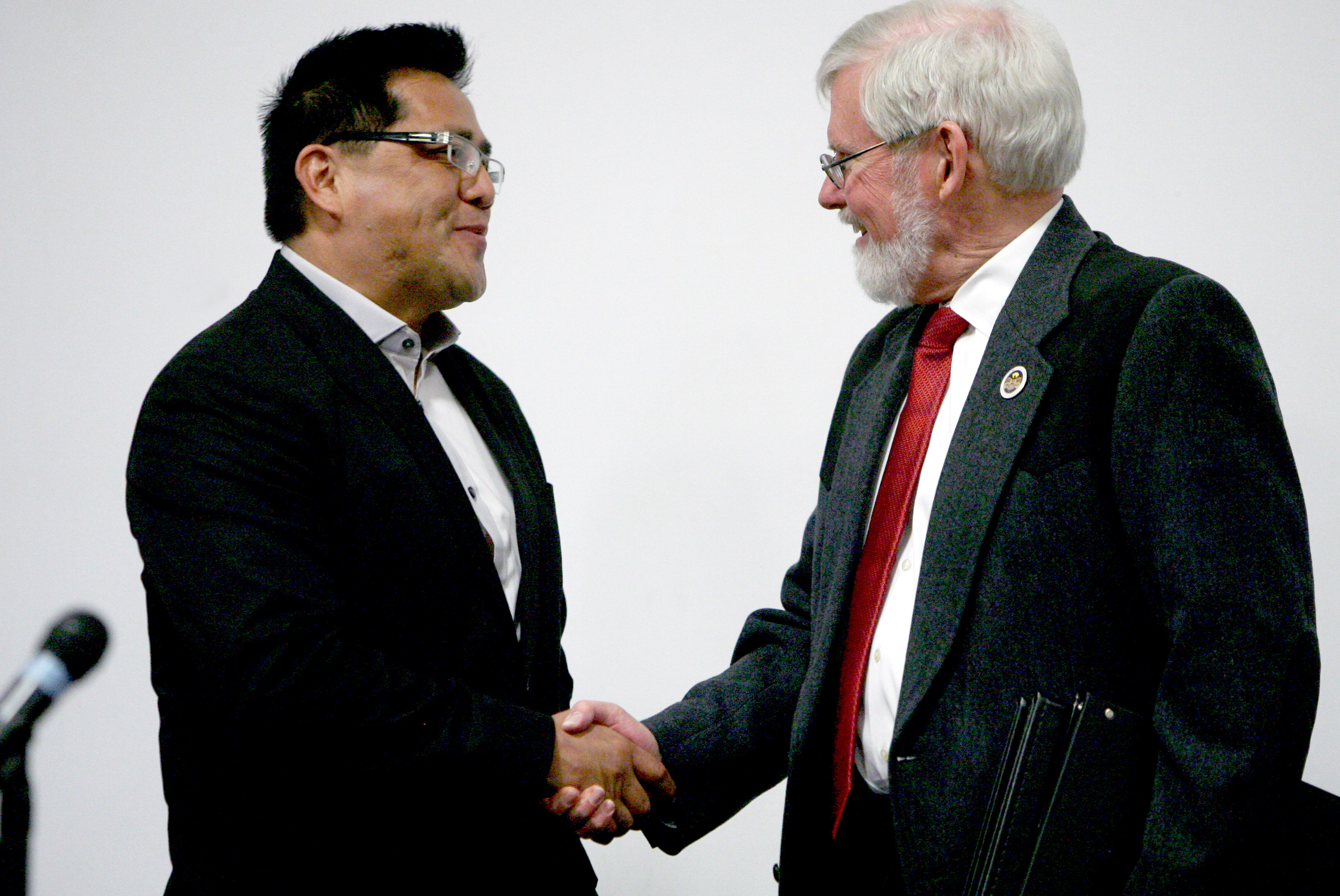 Ute Tribe Chairman Gordon Howell, left, and University of Utah
President David Pershing shake hands Tuesday, April 15, 2014,
before signing a new memorandum of understanding that allows
university sports teams to continue using the Ute name and drum
and feather logo. In exchange, the university will provide
scholarships for Native American students, create an unpaid part-
time position to advise Pershing on Native American affairs and its
athletes will take part in outreach events with Native American
children.