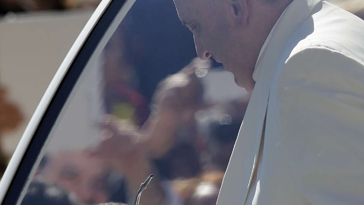 Pope gives a lift to 2 kids in St. Peter's Square