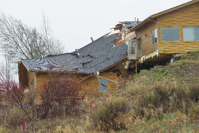 A house breaks apart as a slow-moving 
landslide in Jackson, Wyo. advances downhill on 
Friday, April 18. 2014. The slide has cut off 
access to a 60-person neighborhood and has 
threatened town utilities, including a water 
line.
