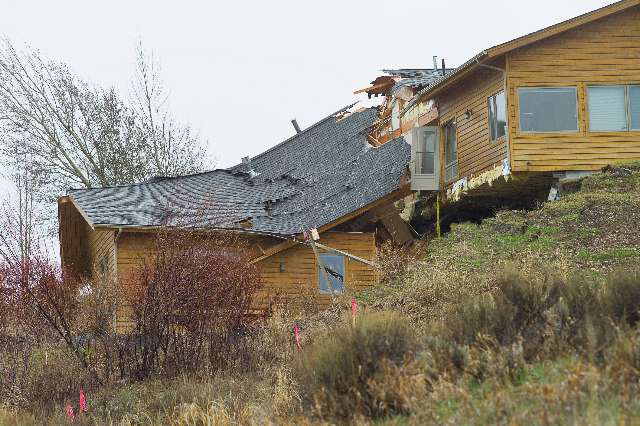 A house breaks apart as a slow-moving
landslide in Jackson, Wyo. advances downhill on
Friday, April 18. 2014. The slide has cut off
access to a 60-person neighborhood and has
threatened town utilities, including a water
line.