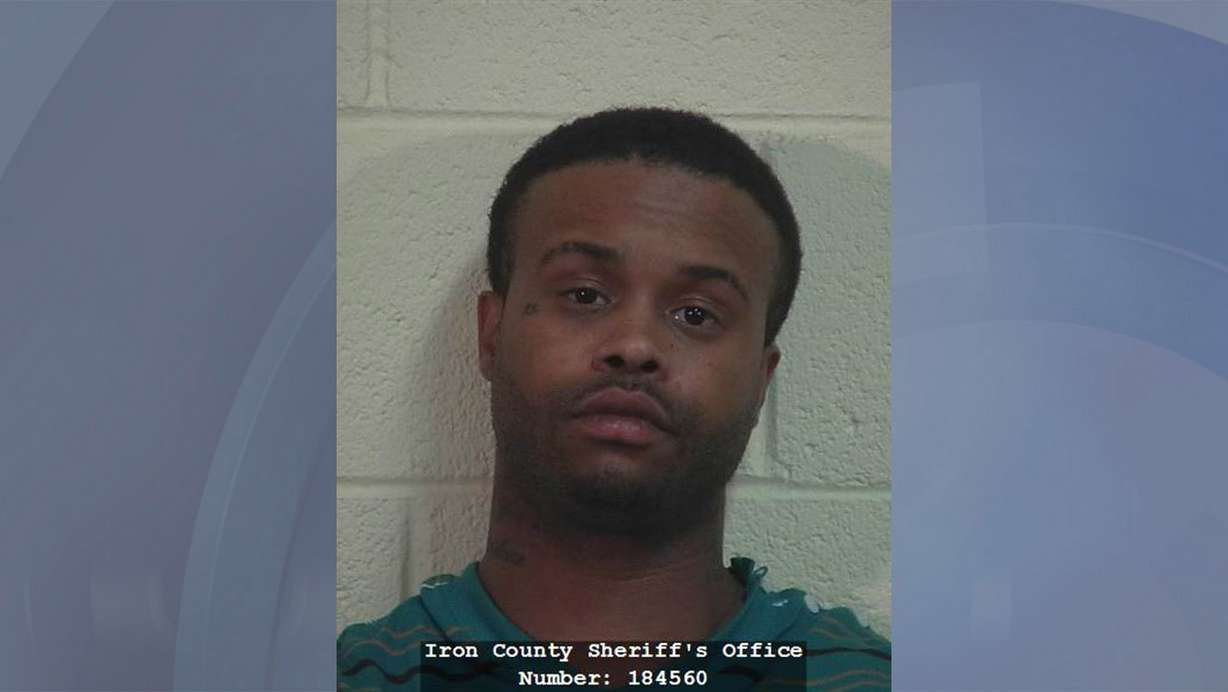 Zeland Adams, 28, was booked into the Iron
Sheriff's Office Sunday after evading police
and holding a 2-year-old boy hostage in a
standoff on I-15.