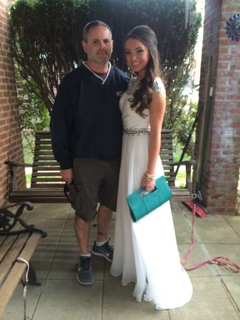 Senior Abby Rodgers, here with her father, went
without a date to St. Basil Academy's prom in
suburban Philadelphia.