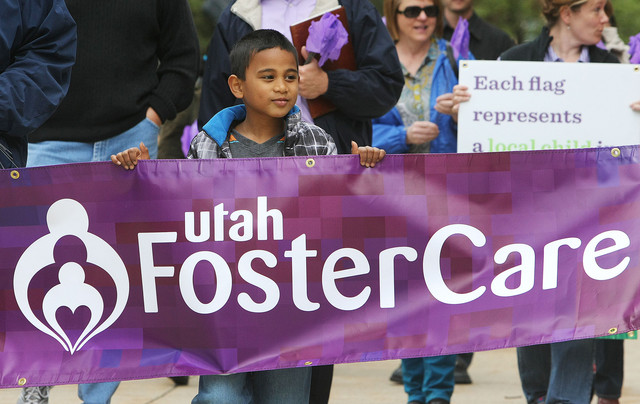 Tayler Sumsion walks with his family and others around the Salt Lake City-County Building to honor foster care families as part of National Foster Care Month. A recent report ranked Utah first in the nation for for placing foster children in safe, stable homes.