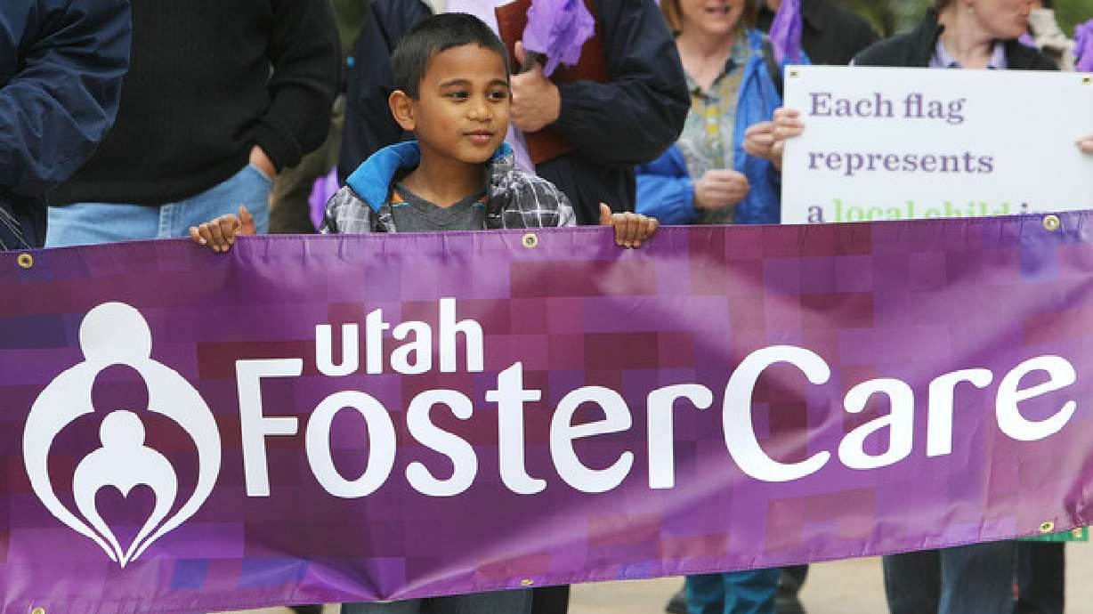 Tayler Sumsion walks with his family and others around the Salt Lake City-County Building to honor foster care families as part of National Foster Care Month. A recent report ranked Utah first in the nation for for placing foster children in safe, stable homes.