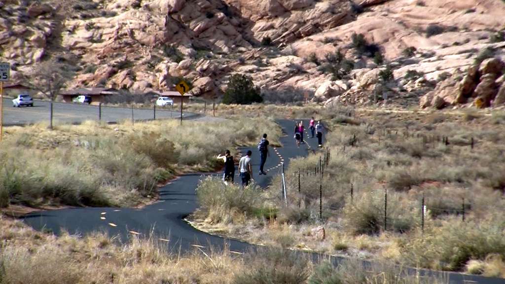Walkers and skateboarders travel down a paved
bike trail near Moab. It's part of a flurry of
bike trail construction and planning in various
parts of the state is beginning to connect Utah
communities to the great outdoors. (Photo: KSL
TV)
