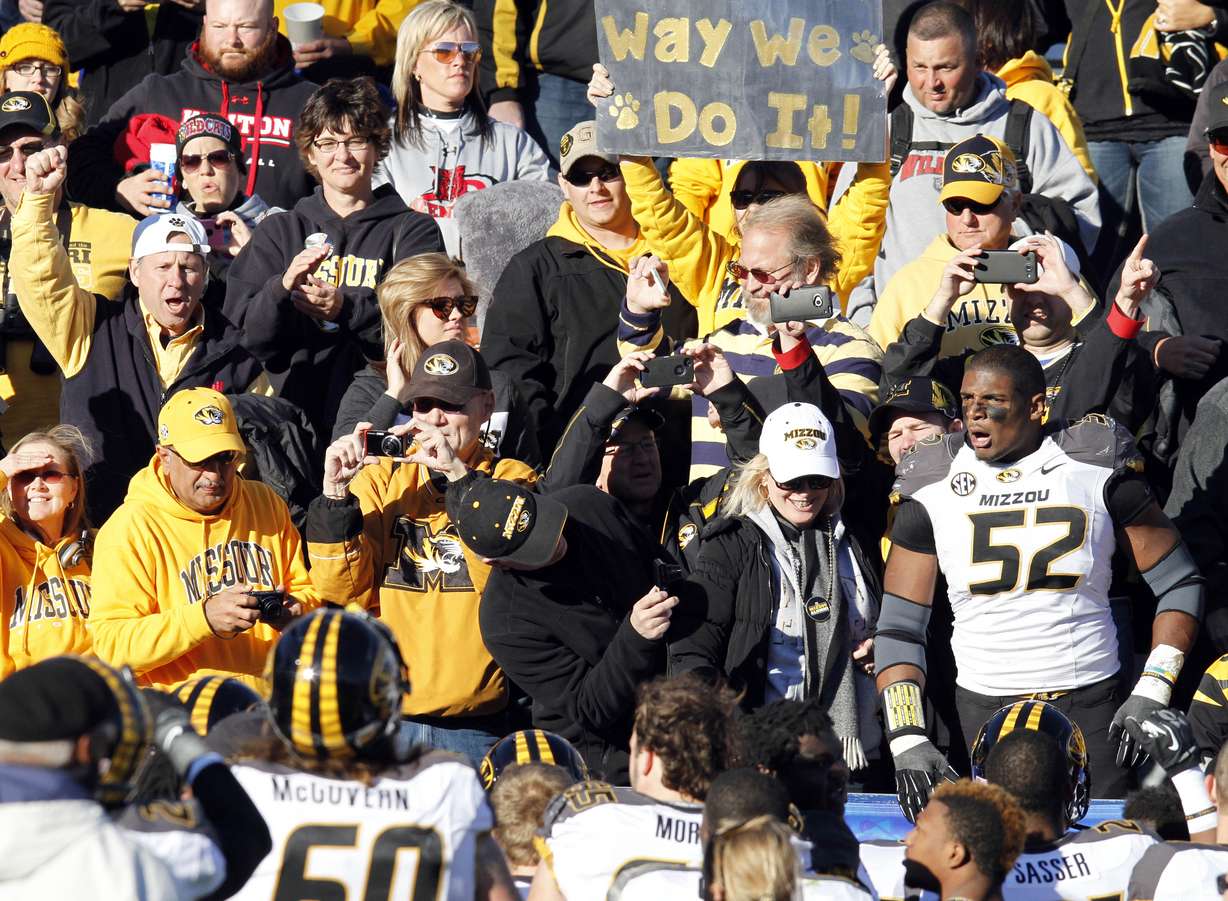 FILE - In this Nov. 9, 2013 file photo, Missouri's Michael Sam (52)
celebrates in the stands with Missouri fans after an NCAA college
football game against Kentucky, in Lexington, Ky. When Sam was
drafted by the St. Louis Rams on May 10, 2014, he became the first
openly gay player ever drafted by an NFL team. It is a milestone has
made longtime gay fans all the more enthusiastic, and already is
drawing newcomers into the fold. (AP Photo/James Crisp, File)