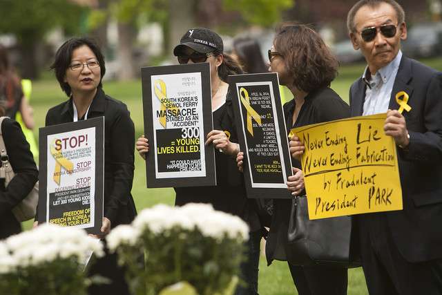 A group gathers Sunday, May 18, 2014 at Liberty Park to bring
awareness to the South Korean ferry sinking that resulted in the loss
of over 300 high school age kids.