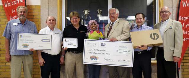 Student Syeda Hashmi poses with donors after receiving scholarship
funds and gifts at Granite Park Junior High in Salt Lake City,
Wednesday, May 28, 2014.