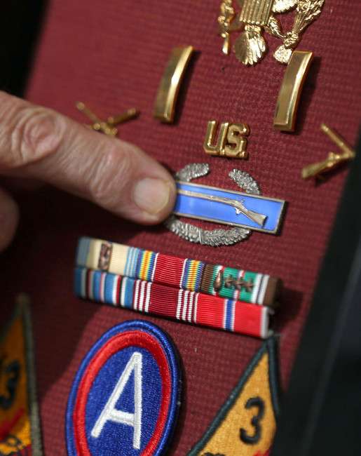 Howard Clements points to the combat infantry badge that he received
for his service during World War II, on Wednesday, June 4, 2014.