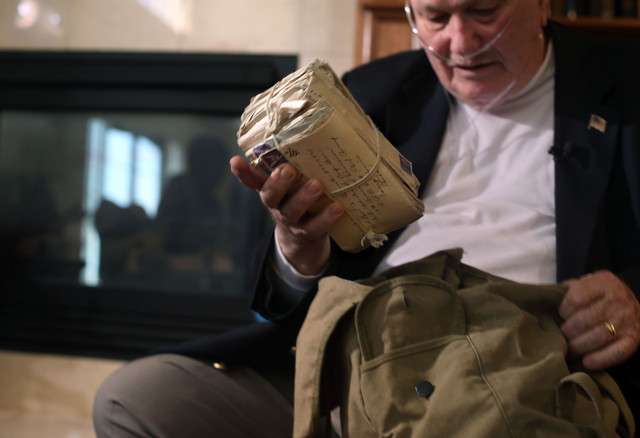 World War II veteran Howard Clements holds a stack of letters from his
wife at Coventry Retirement Community in Sandy on Wednesday, June
4, 2014. Clements kept every letter that his wife wrote him while he
was serving in World War II; a letter every day for the three years that
they were apart.