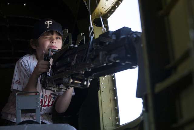 Cash Hunter, 8, pretends to fire a machine gun on the B-25 Maid in
the Shade at the Heber City Airport, Monday, June 9, 2014. The
historic plane was restored by the Arizona Wing of the
Commemorative Air Force. It was commissioned into the Army Air
Force on June 9, 1944. (Photo: Michelle Tessier, Deseret News)
