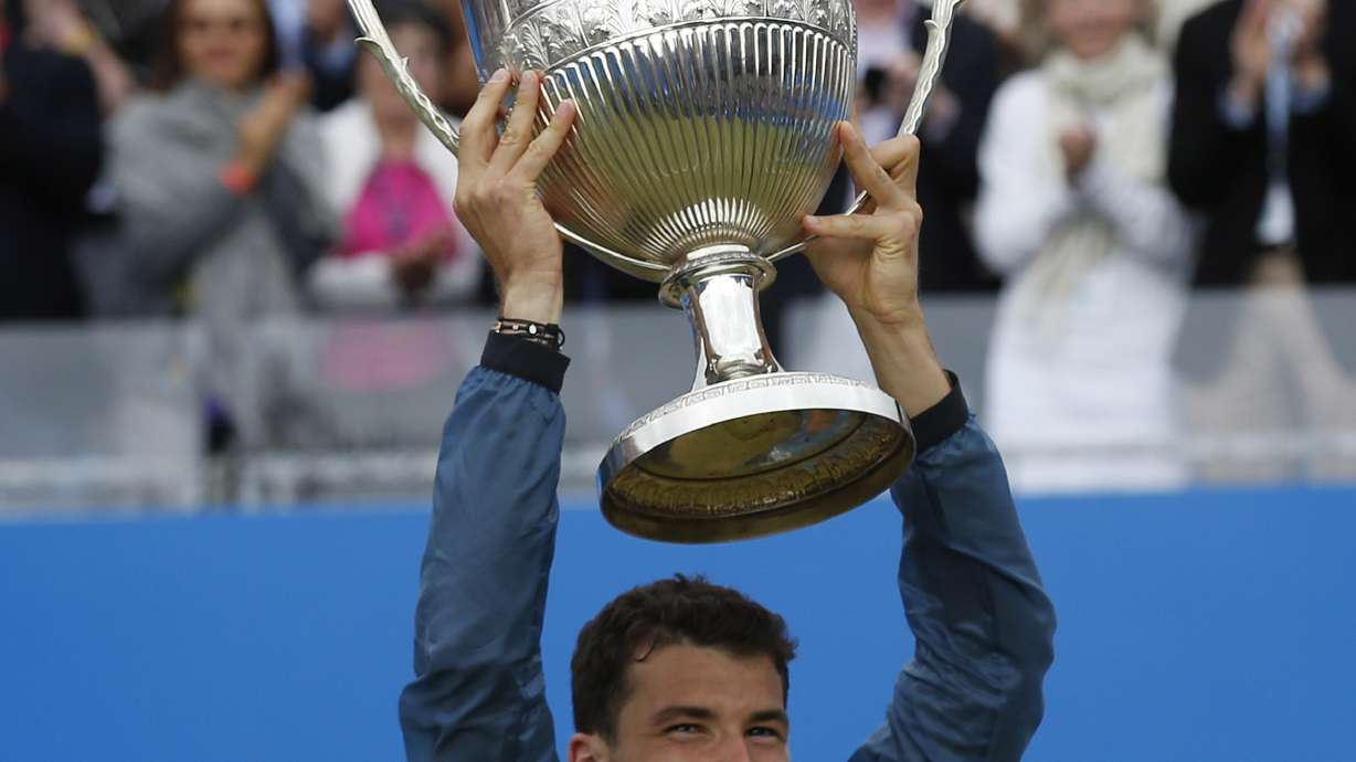 Dimitrov saves match point to win Queen's final