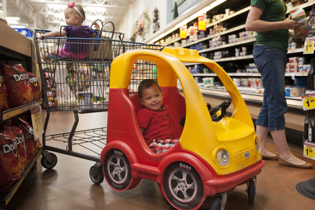 Nigel Paat, 3, smiles in a shopping cart along with 
Laneah Paat, 1, left, 
as Kara Paat shops at Smith's Marketplace in Lehi, 
Friday, June 6, 
2014. Smith's is launching a campaign as part of 
National Safety Month 
to educate parents on how to use shopping carts 
safely.