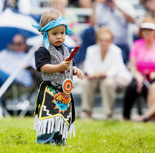 Rain Losee admires some bells during a dance as native americans join 
together Sunday, June 15, 2014, for a pow wow in Midway.