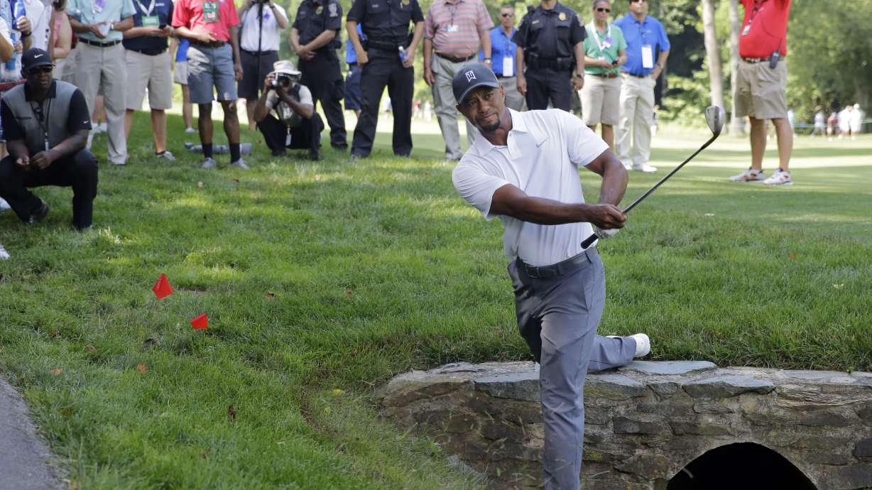 Woods misses the cut, and a 4-way tie for the lead