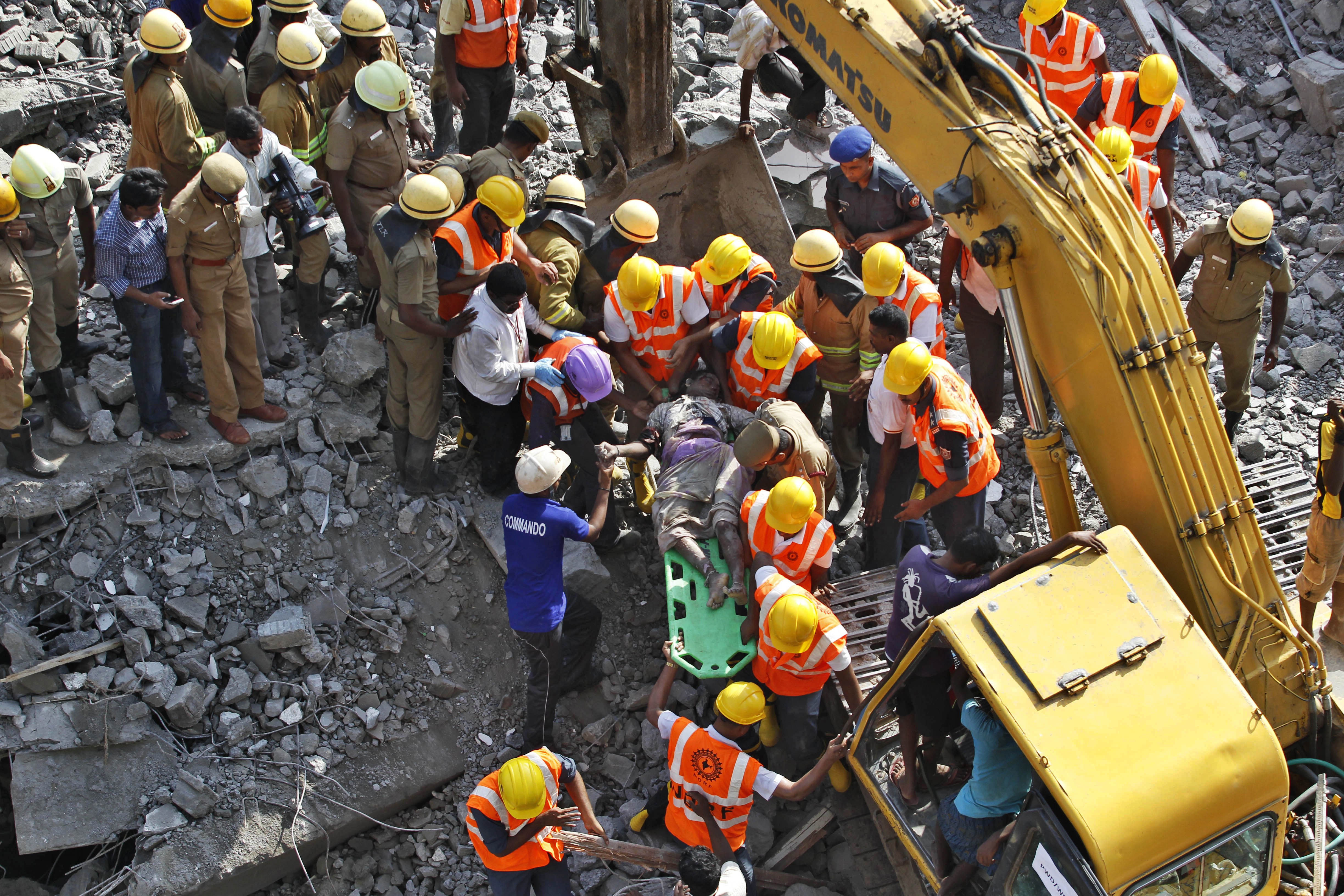 Rescuers dig for survivors in India building ruins