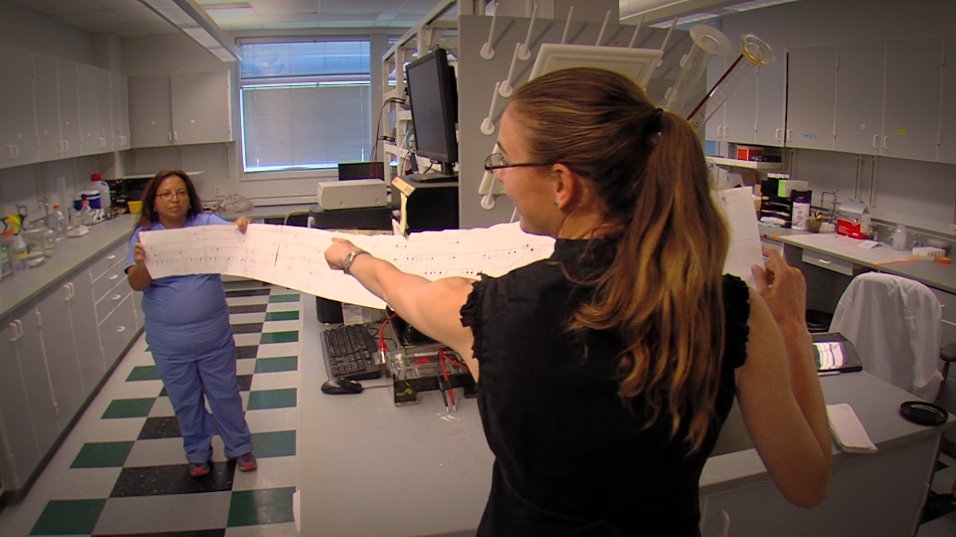 Dr. Summer Gibson with the University of Utah's
ALS clinic shows a genetic map researchers have
compiled of ALS patients and their progenitors.
Gibson and other researchers hope the data
eventually lead them to a cure for ALS. (Photo:
Ken Fall, KSL TV)