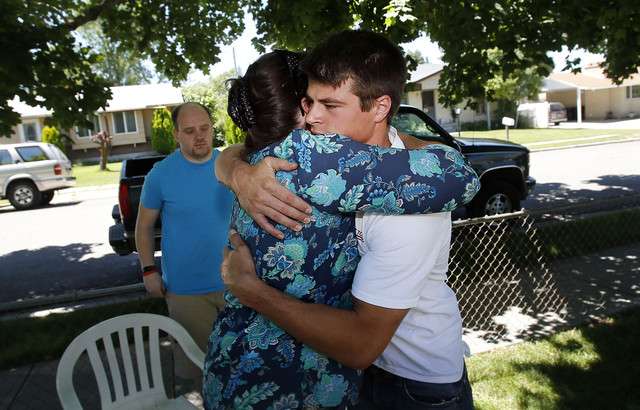 Jackie Page, aunt to missionary Matt Palmer, hugs Tom Smith, friend
of Matt Palmer as family and friends gather at his home in Woods
Cross, Tuesday, July 1, 2014.