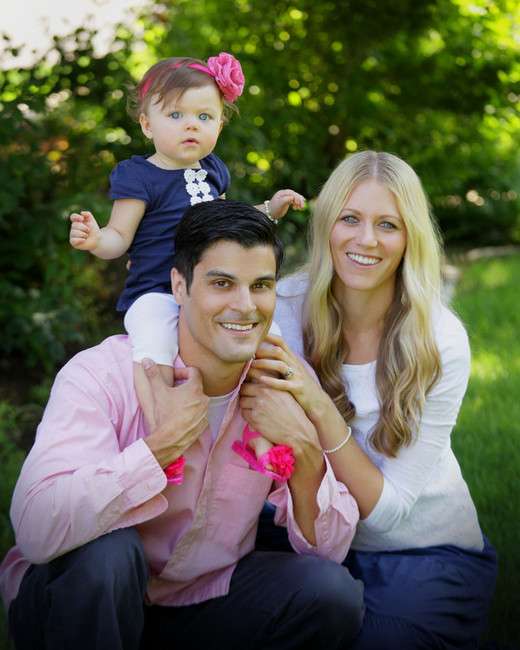 Kim White with her husband and 1-year-old daughter. Photo Credit:
Kim White