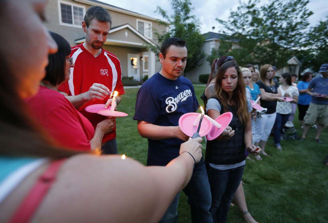 Friends gather during a candle light vigil in Logan Thursday, July 10,
2014. Ronald Lee Haskell, a recent Logan resident, has been charged
with multiple counts of capital murder in a shooting in Texas. Haskell
and his family lived in Logan for several years. (Submission date:
07/10/2014)