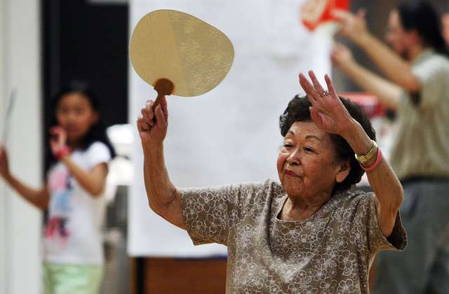 Maxine Furubayashi, 93, gives instruction to
dancers as they prepare Wednesday, July 9,
2014, at the Salt Lake Buddhist Temple for the
Obon dance festival planned for Saturday, July
12.
