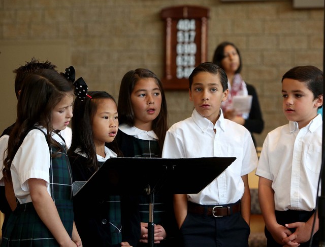Third-grade students at St. John The Baptist Catholic Elementary 
School in Draper speak during Mass in November of 2013.