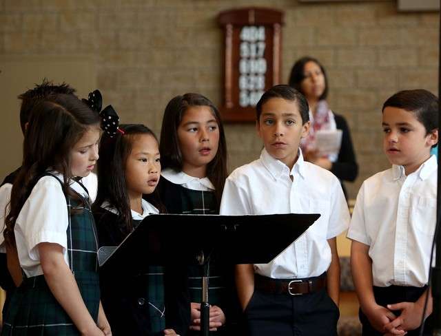 Third-grade students at St. John The Baptist Catholic Elementary
School in Draper speak during Mass in November of 2013.