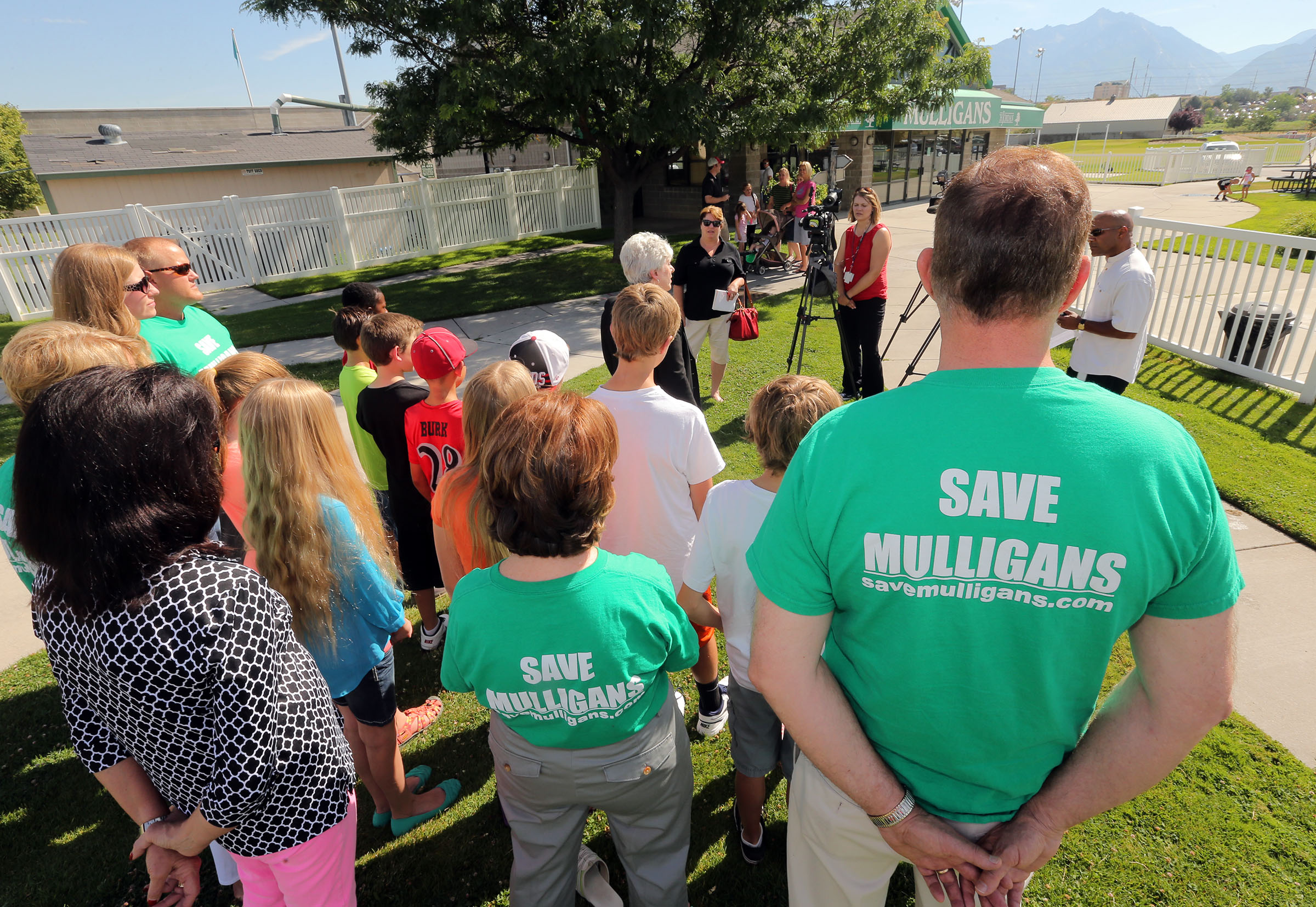 Julie Holbrook, president of Save Mulligans,
and others gather Monday, July 14, 2014, at
Mulligans in South Jordan trying to save the
facility.