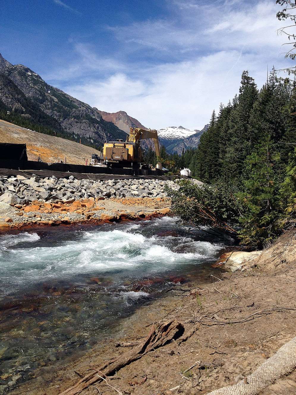 Railroad Creek rushes by discolored rocks at the Rio Tinto Mine remediation project in Washington.