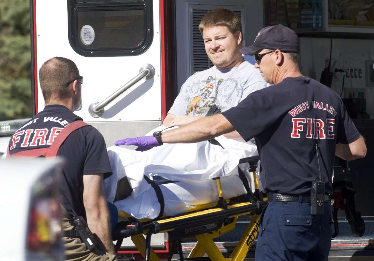 West Valley police detective Shaun Cowley is taken to an ambulance by paramedics shortly after shooting and killing Danielle Willard, 21, during a botched undercover drug operation at the Lexington Park apartments near 3715 South and 2200 West on Nov. 2, 2012. He has since been charged with manslaughter, a second-degree felony, in the killing. (Photo: Scott G Winterton, Deseret News)