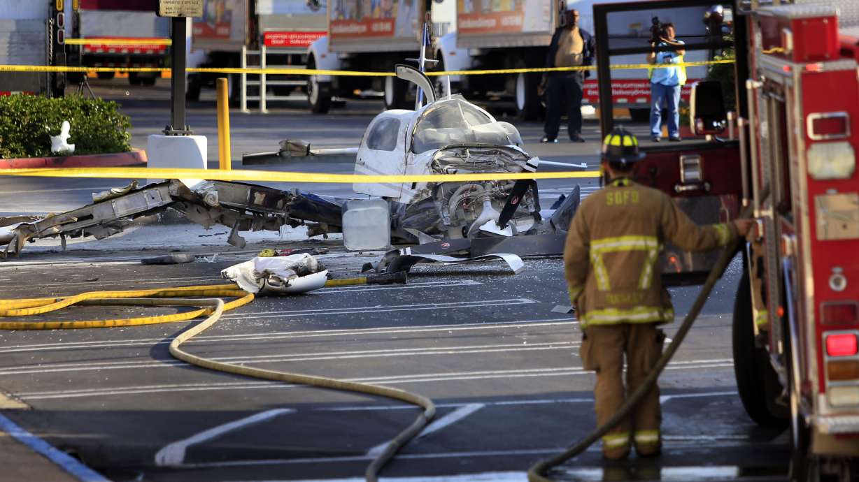 Passenger dies, pilot hurt in parking lot crash
