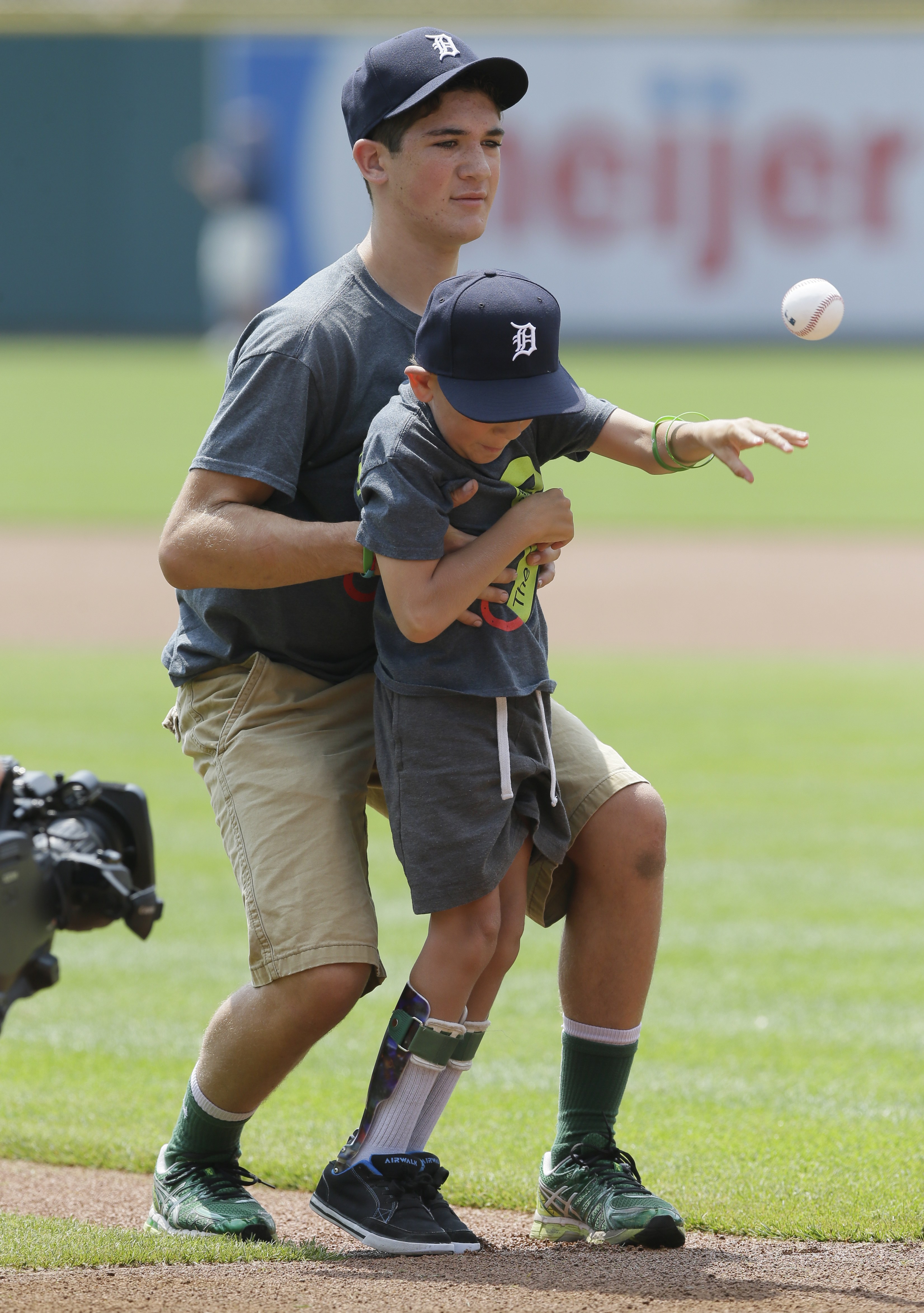Brothers who walked 40 miles throw 1st Tiger pitch