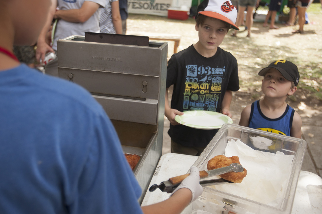 Xen Ballato, 9, left, and Quinn Ballato, 4, wait on scones during the farmers market at Wheeler Historic Farm on Sunday, Aug. 3, 2014. (Photo: Michelle Tessier, Deseret News)