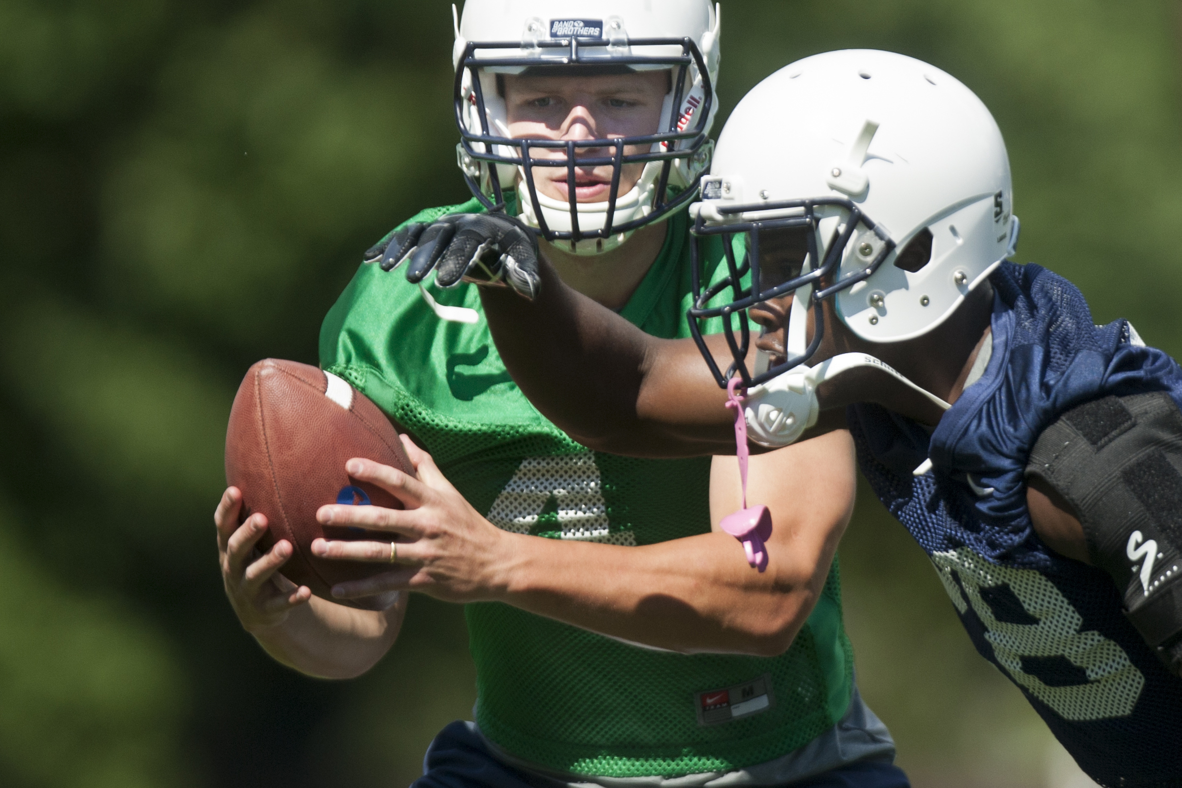 Quarterback Taysom Hill makes a play action fake during BYU football camp at SAB outdoor practice field, Friday, Aug. 1, 2014.