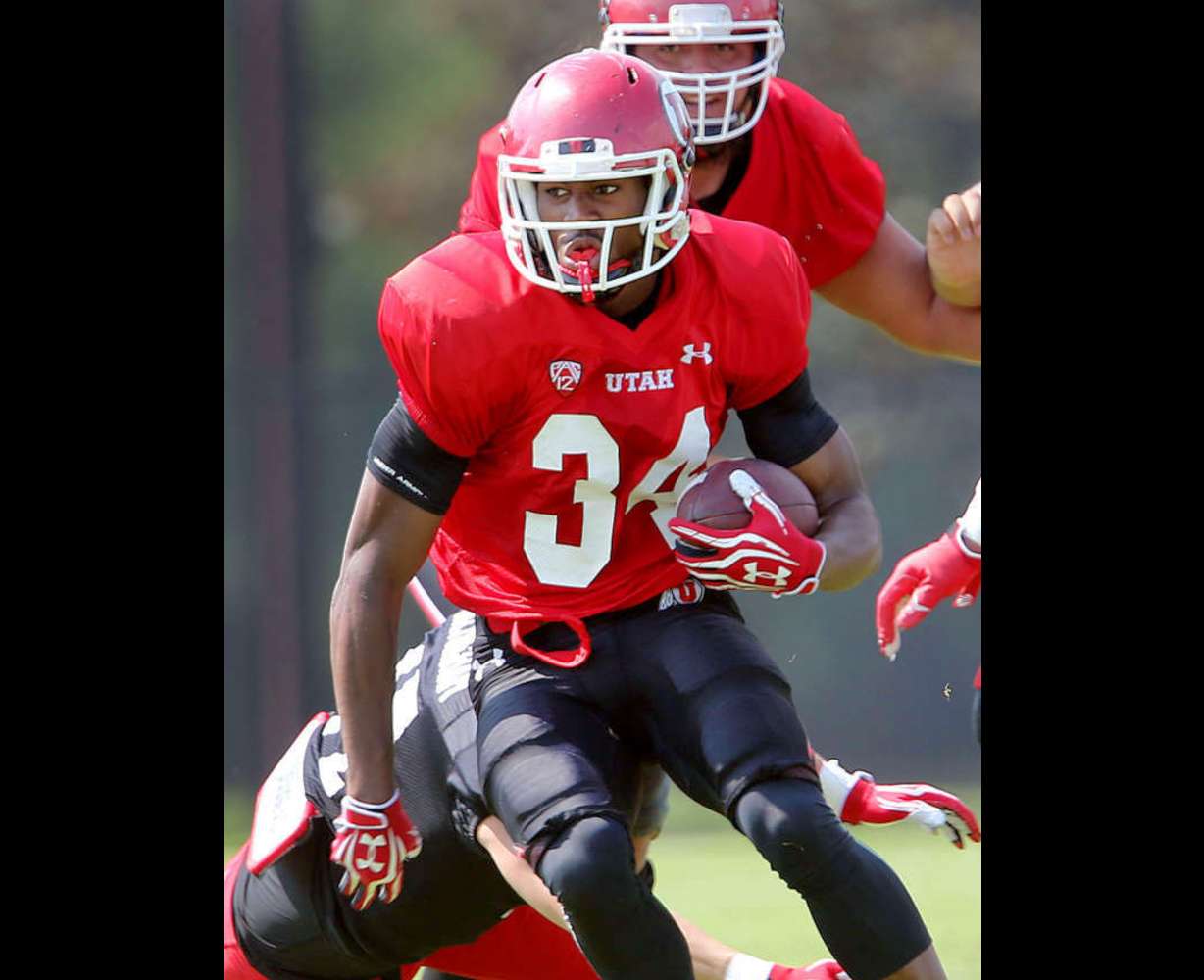 Bubba Poole looks for running room as Utah practices Friday, Aug. 8, 2014, at the University of Utah. (Scott G Winterton, Deseret News)