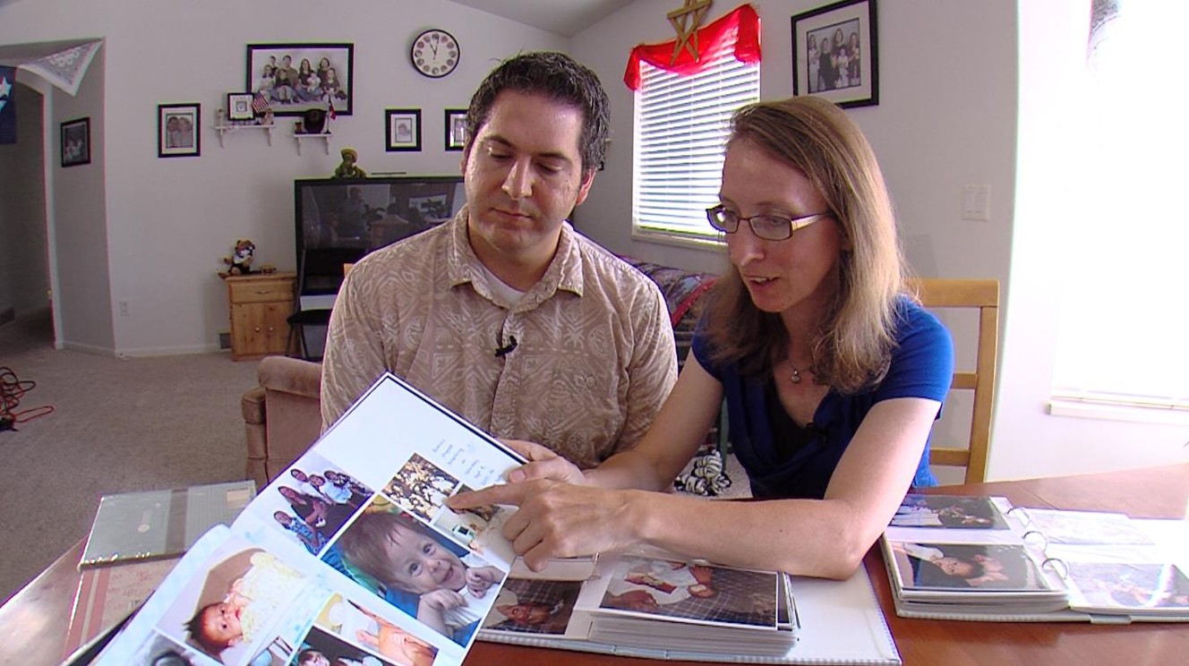 Chris and Marie Nuccetelli, of Lehi, look at photos of their boy who died in 2001. They also lost a girl in 2007. Both babies had undiagnosed conditions. (Photo: Ken Fall, KSL TV)