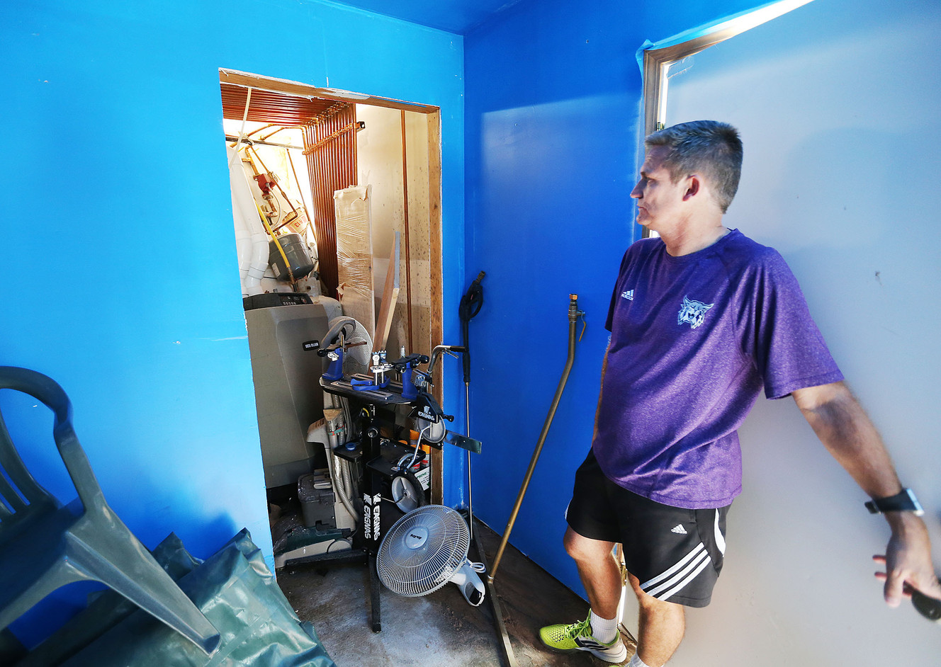 Eagleridge Tennis and Swim Club owner Brad Ferreira points out areas of damage to club facilities following the North Salt Lake landslide, Wednesday, Aug. 13, 2014.