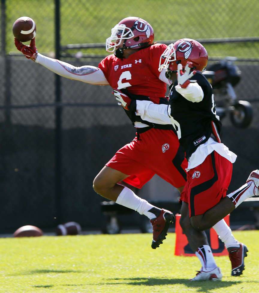 Dres Anderson pulls in a pass with Eric Rowe at right during University of Utah football practice in Salt Lake City, Monday, Aug. 18, 2014. (Credit: Ravell Call)