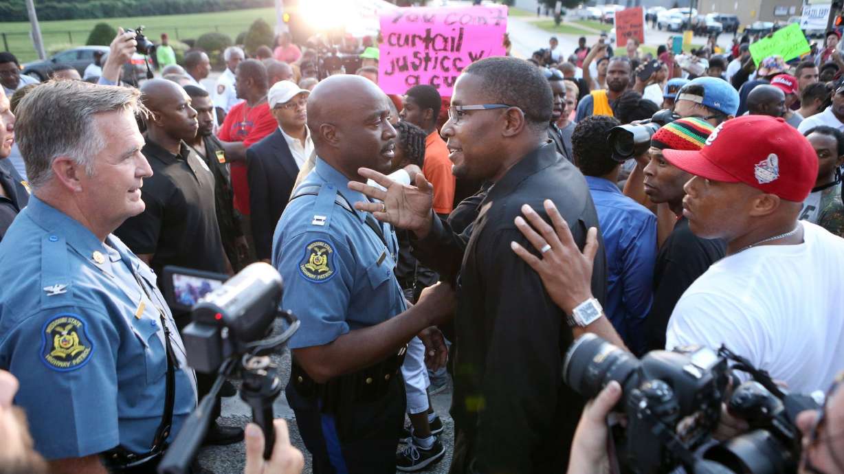 Volunteers a buffer between police, protesters
