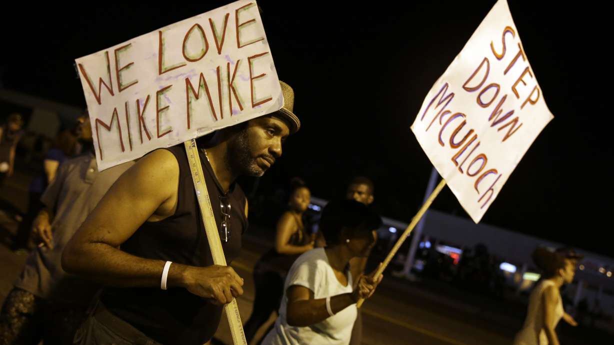 Protesters, police march peacefully in Ferguson