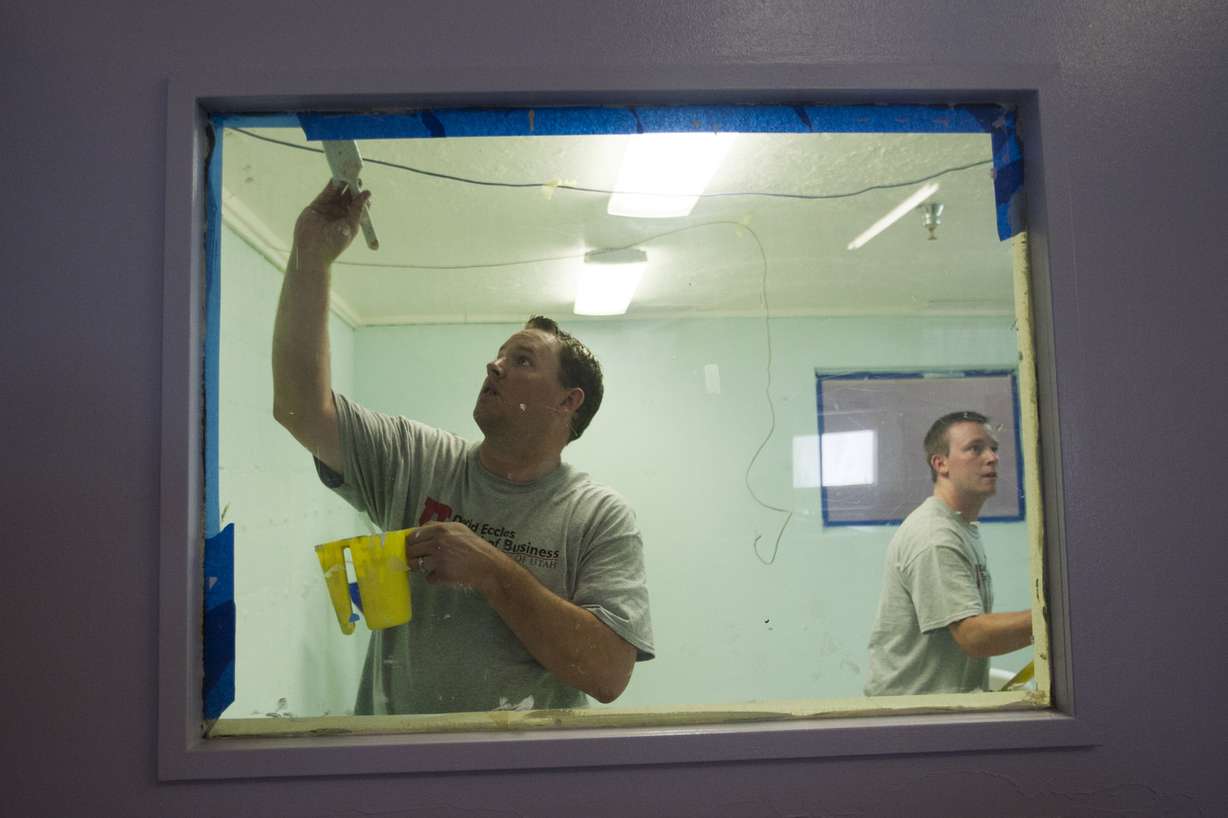 Johnny Jensen paints a room with Rick Gallacher, right, as students and faculty from the accounting master's degree program at the University of Utah's David Eccles School of Business cleaned up the Road Home Community Winter Shelter in Midvale for the coming winter season, Wednesday, Aug. 20, 2014.