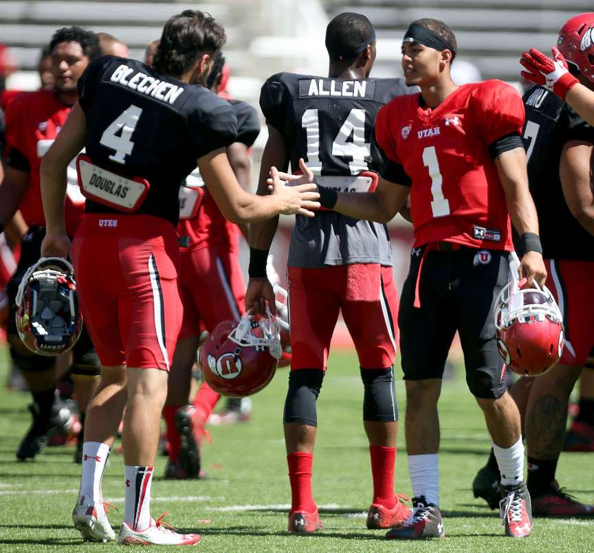 Brian Blechen and Kendal Thompson shake hands after a University of Utah football scrimmage at the Rice-Eccles Stadium in Salt Lake City on Saturday, Aug. 16, 2014.