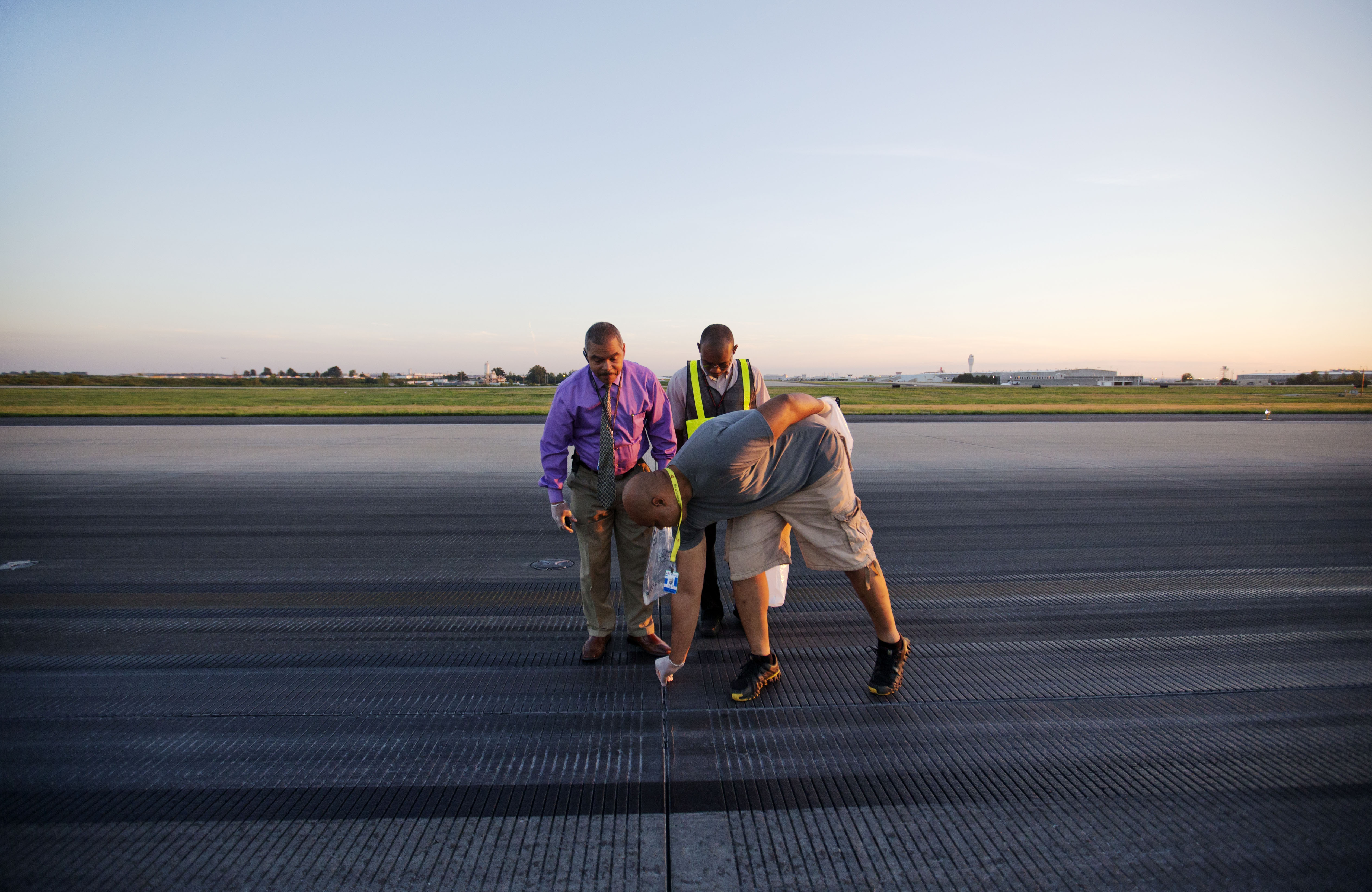 AP PHOTOS: Workers clear debris from busy runway