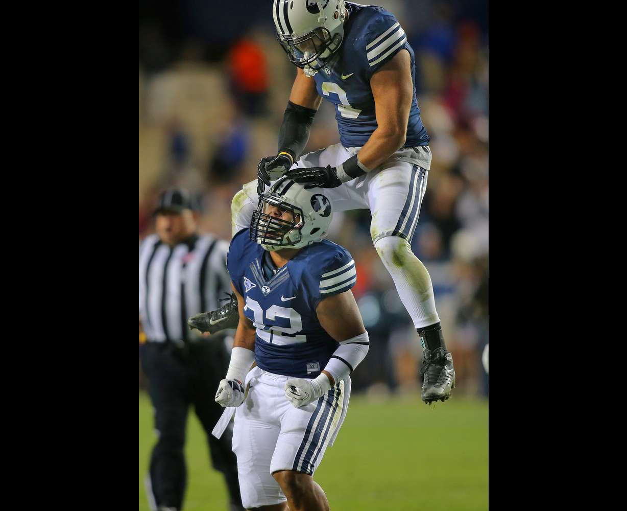 Brigham Young Cougars linebacker Manoa Pikula (22) celebrates with BYU linebacker Kyle Van Noy (3) after a sack as the Cougars play Middle Tennessee State Friday, Sept. 27, 2013, in Provo.