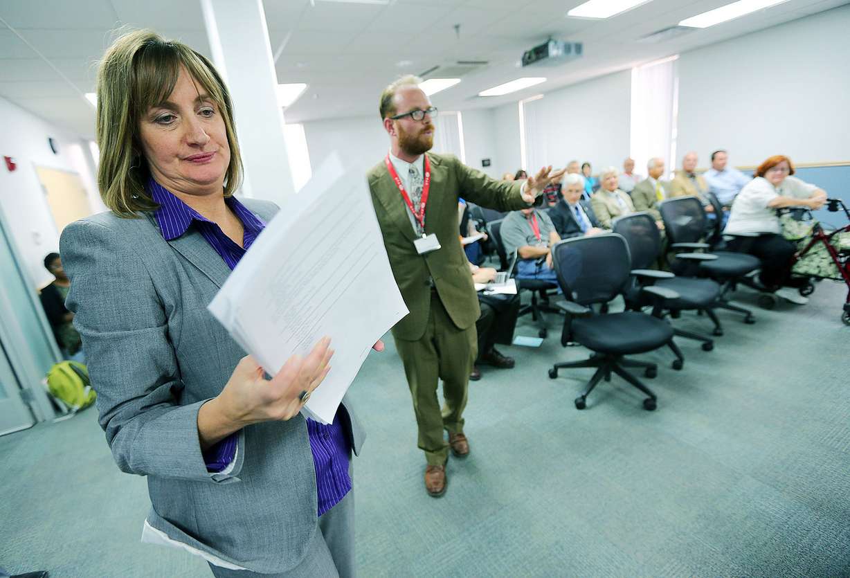 Alex Cragun hands a petition to Andrea Packer of UTA after he spoke to members of Utah Transit Authority's board in Salt Lake City Wednesday, Aug. 27, 2014, asking for expanded service hours. (Photo: Scott G Winterton, Deseret News)