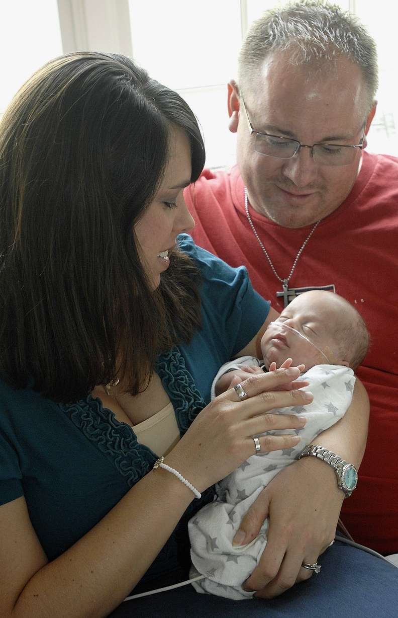 In this Aug. 5, 2014 photo, Josh and Nicole Nyberg of Bloomington, Ill., hold their son, William, who was born prematurely at 23 weeks and weighed 1 pound 6 ounces on April 28th. William came home on July 28, three weeks before his Aug. 21 due date.